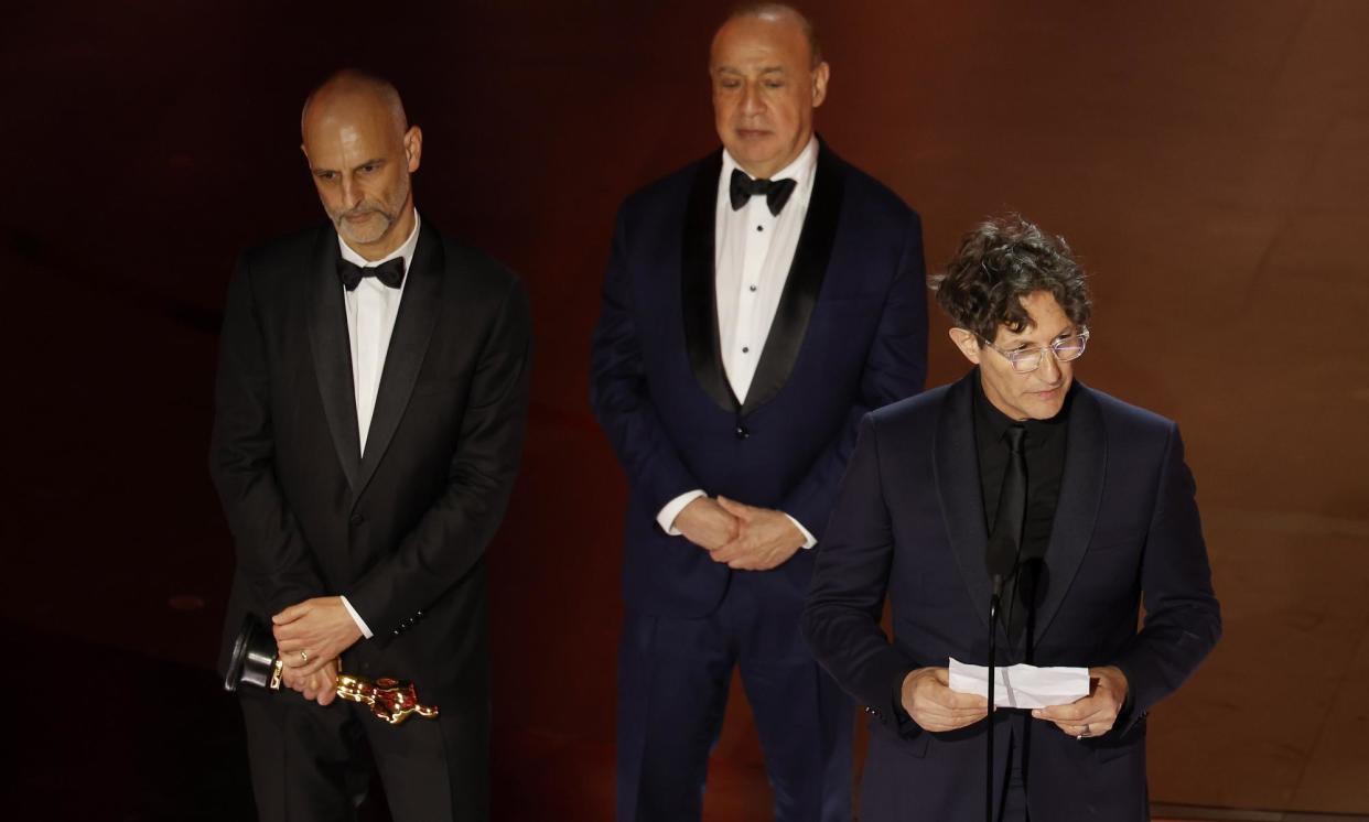 <span>Controversy … (left to right) producers James Wilson, Leonard Blavatnik and director Jonathan Glazer collect the Oscar for best international film for The Zone of Interest.</span><span>Photograph: Caroline Brehman/EPA</span>