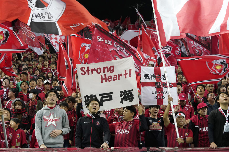 Urawa Reds supporters cheer during the second leg of the AFC Champions League final soccer match between Urawa Reds and Al Hilal in Saitama, near Tokyo, Sunday, Nov. 24, 2019. (AP Photo/Christopher Jue)