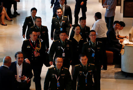 FILE PHOTO: People's Liberation Army's Lieutenant-General He Lei (C) arrives at the IISS Shangri-la Dialogue in Singapore June 1, 2018. REUTERS/Edgar Su/File Photo