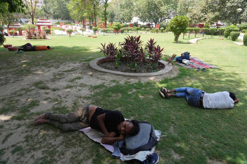 People rest under the shade of trees to beat the intense heat in Lucknow in the the Indian state of Uttar Pradesh, Wednesday, April 19, 2023.