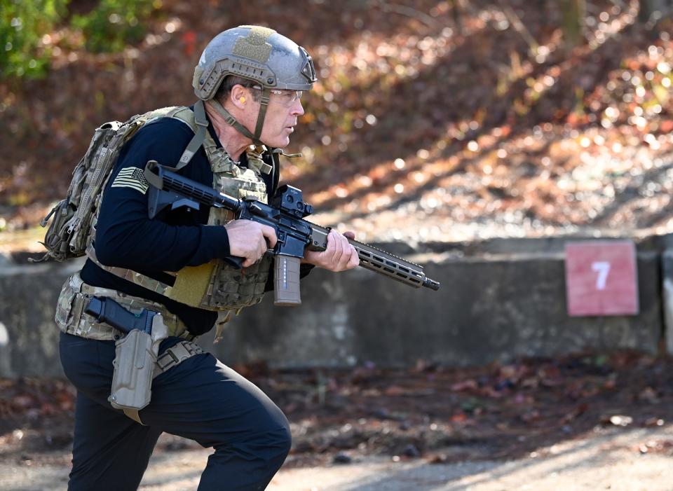 Actor Mark Valley runs with an M4 Carbine while taking part in the 2021 Tactical Challenge at the U.S. Army John F. Kennedy Special Warfare Center and School's Miller Training Complex on Dec. 16, 2021. Twelve celebrities teamed up with Green Berets to take part in the annual event.