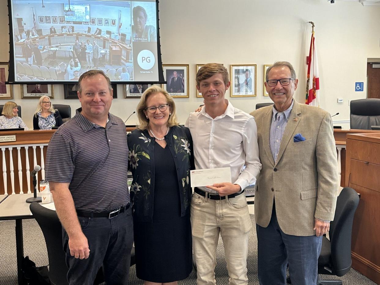 Robert Lebrun (second from right) received the Palm Beach Civic Association and Citizens' Association of Palm Beach Scholarship Award at the Aug. 8 Town Council meeting. With him are (from left) his father, Brian Lebrun, Council President Maggie Zeidman, and Citizens' Association Co-Chairman Skip Aldridge.