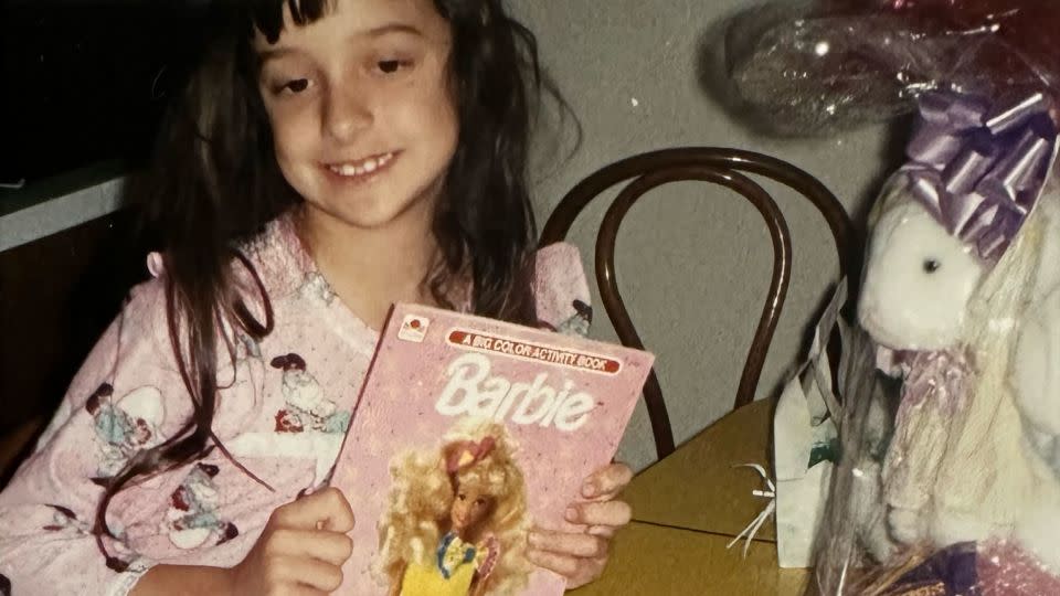 As a child, Koelker says she had about 15 Barbie dolls and two Ken dolls. Here she is seen holding a Barbie coloring book. - Courtesy Barbie Koelker