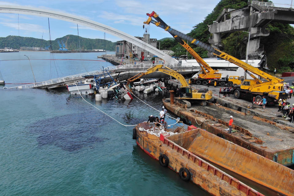 A collapsed bridge is seen in Nanfangao, eastern Taiwan. Tuesday, Oct. 1, 2019. A towering bridge over a bay in eastern Taiwan has collapsed sending an oil tanker truck falling onto boats in the water below.(Taiwan's National Fire Agency via AP)