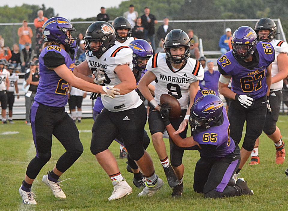 Sioux Falls Washington quarterback Thomas Hoffman is brought down by Watertown's Jayden Lambert during Watertown High School's homecoming football game on Friday, Sept. 15, 2023 at Watertown Stadium. Also pictured are Watertown's Kaden Decker (28) and Caden Beauchamp (67) and Washington's Benjamin Alberts (62).