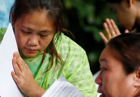 Family members pray near the Tham Luang cave complex during a search for members of an under-16 soccer team and their coach, in the northern province of Chiang Rai, Thailand, June 27, 2018. REUTERS/Soe Zeya Tun