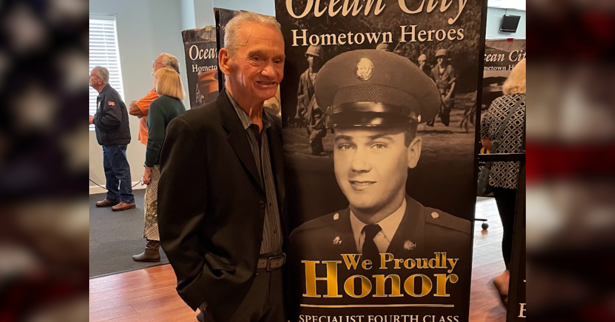 David McAllister stands next to a banner honoring his Vietnam service. Photo courtesy of Matt McAllister.