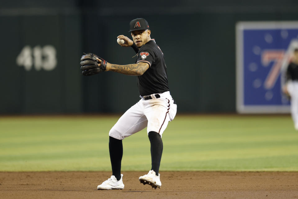 Arizona Diamondbacks second baseman Ketel Marte throws to first for the out on Chicago Cubs' Ildemaro Vargas during the third inning of a baseball game Saturday, May 14, 2022, in Phoenix. (AP Photo/Chris Coduto)