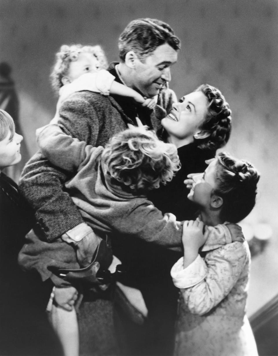 Karolyn Grimes, top left, with Jimmy Stewart, Donna Reed and the cast of Frank Capra's "It's a Wonderful Life."
