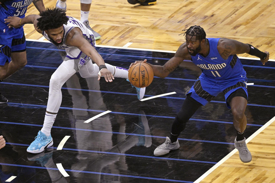 Orlando Magic forward James Ennis III (11) steals the ball from Sacramento Kings forward Marvin Bagley III (35) during the second half of an NBA basketball game Wednesday, Jan. 27, 2021, in Orlando, Fla. (AP Photo/Phelan M. Ebenhack)