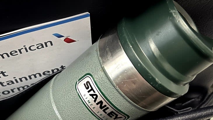 Stanley water bottle in seatback pocket on airplane; zero waste travel kit