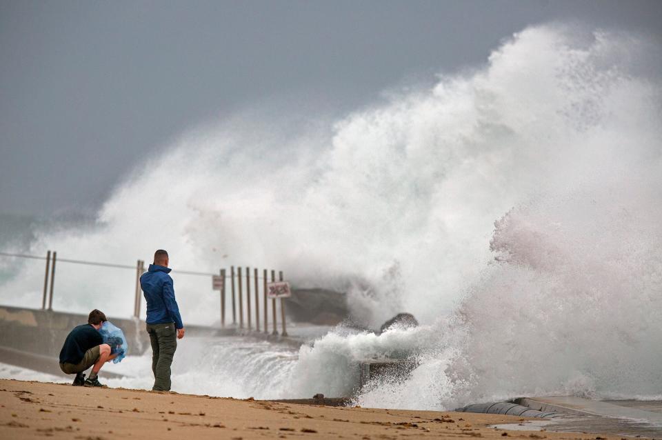 Waves driven by Tropical Storm Isaias crash over the jetty on the north side of the Palm Beach Inlet on Aug. 2, 2020.