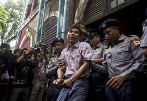 Myanmar journalist Kyaw Soe Oo is escorted out of the court