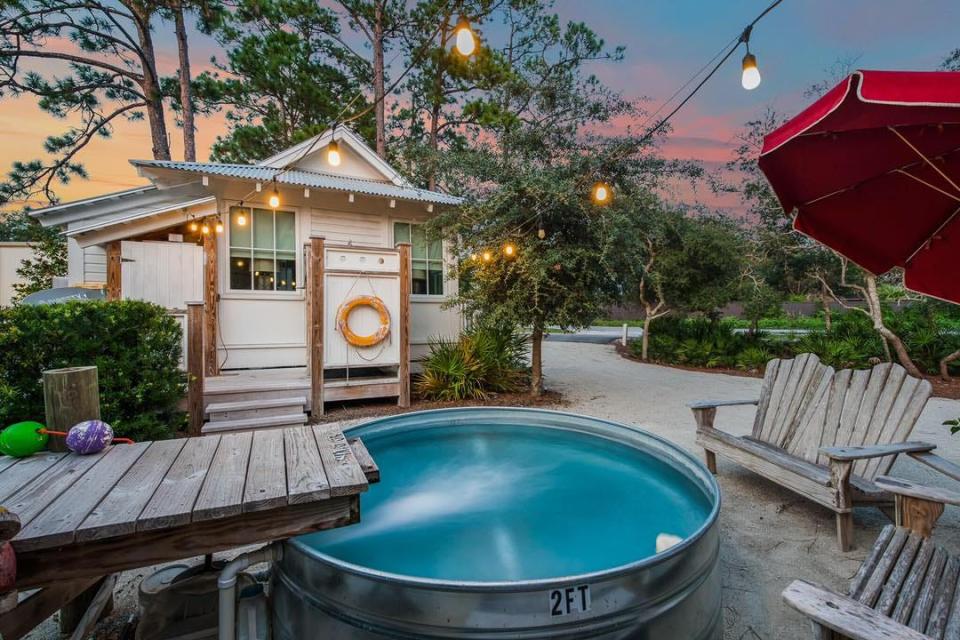 This 196-square-foot home at 2826 South County Road 395 in Santa Rosa Beach features a stock tank splash pool with a lounging area and an outdoor shower. The home is listed for sale at $1,095,000 on Zillow.