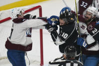 Colorado Avalanche left wing J.T. Compher, left, and Los Angeles Kings center Michael Amadio (10) fight during the first period of an NHL hockey game Thursday, Jan. 21, 2021, in Los Angeles. (AP Photo/Ashley Landis)