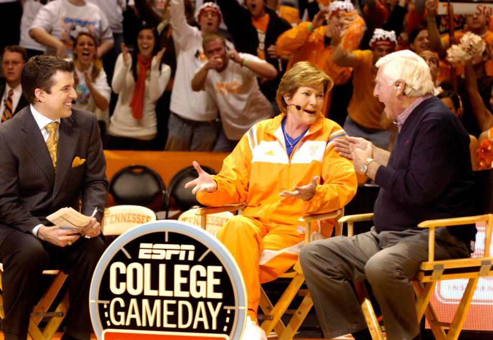 In this 2009 photo, ESPN's Rece Davis, left, looks on as University of Tennessee Lady Vols basketball coach Pat Summitt talks with coaching legend Bobby Knight about her run at 1,000 career victories during a live broadcast Saturday of the ESPN College Gameday show at Thompson-Boling Arena.