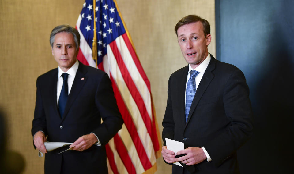 Secretary of State Antony Blinken, left, listens as National Security Adviser Jake Sullivan, right, talks to the media after a closed-door morning session of US-China talks in Anchorage, Alaska on Friday, March 19, 2021. (Frederic J. Brown/Pool via AP)