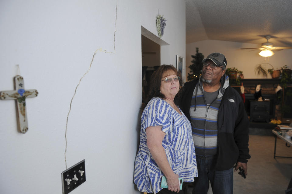 Al and Lyn Matthews show structural cracks in their home in south Anchorage, Alaska, following earthquakes Friday, Nov. 30, 2018. (AP Photo/Michael Dinneen)