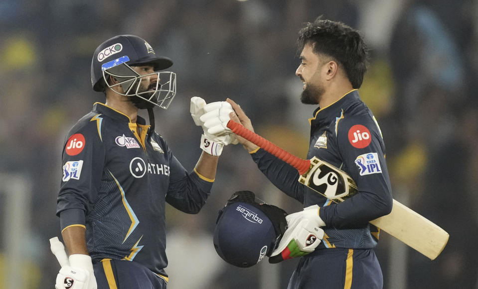 Gujarat Titans' Rahul Tewatia and Rashid Khan, right, celebrate after their team won the Indian Premier League (IPL) match against Chennai Super Kings in Ahmedabad, India, Friday, March 31, 2023. (AP Photo/Ajit Solanki)