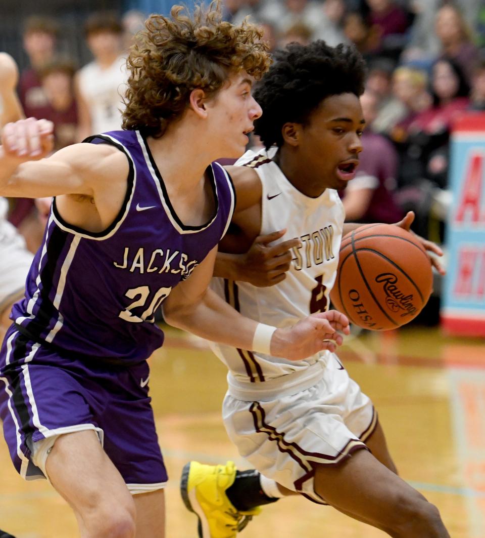 Stow's Titus Baskerville IV is defended by Jackson's Anthony Fuline in the first quarter of the Division I district final, Saturday, March 4, 2023, in Alliance.