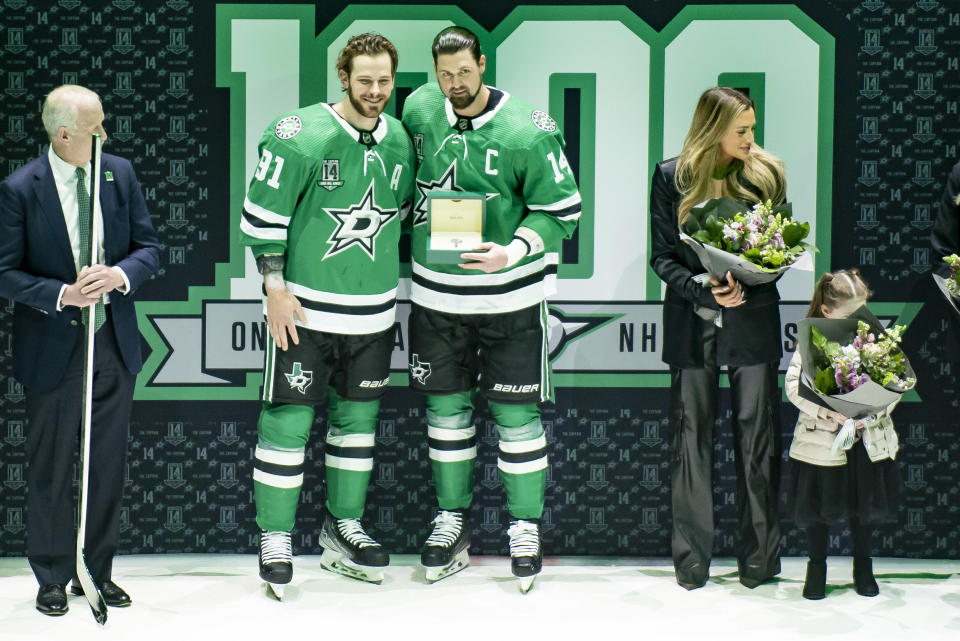 Dallas Stars left wing Jamie Benn (14) and center Tyler Seguin (91) stand together during a ceremony prior to an NHL hockey game against the Colorado Avalanche, Saturday, March 4, 2023, in Dallas. (AP Photo/Emil T. Lippe)