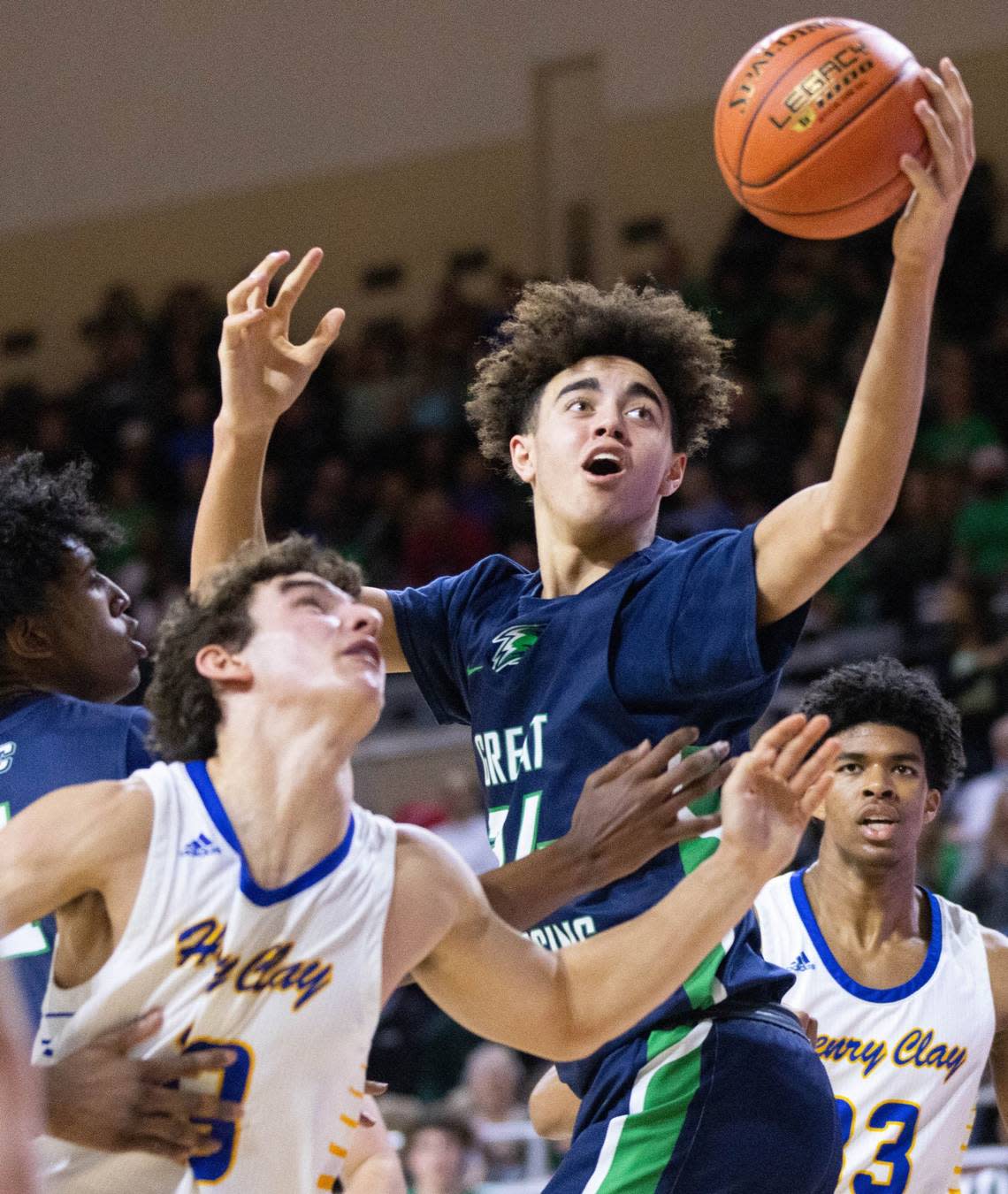 Great Crossing’s Malachi Moreno reaches out for a loose ball during the Warhawks’ game against Henry Clay in the 11th Region tournament semifinals on March 4.