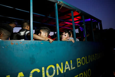 Detainees are seen on a truck after looting during an ongoing blackout in Caracas, Venezuela March 10, 2019. REUTERS/Carlos Garcia Rawlins