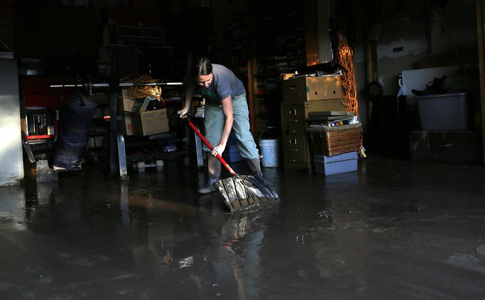 Shanda Roberson shovels flooded mud out of her garage in Longmont, Colorado September 16, 2013. (REUTERS/Rick Wilking)