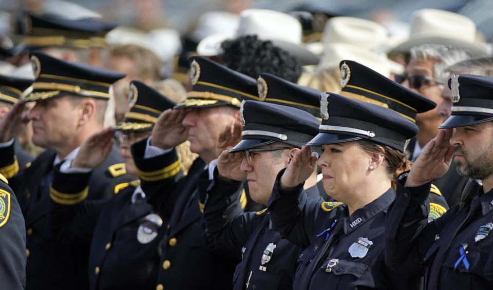 Houston Police Officers salute during a funeral service for Houston police Sgt. Christopher Brewster, Thursday, Dec. 12, 2019, at Grace Church Houston in Houston. Brewster, 32, was gunned down Saturday evening, Dec. 7, while responding to a domestic violence call in Magnolia Park. Police arrested 25-year-old Arturo Solis that night in the shooting death. Solis faces capital murder charges. (AP Photo/David J. Phillip)