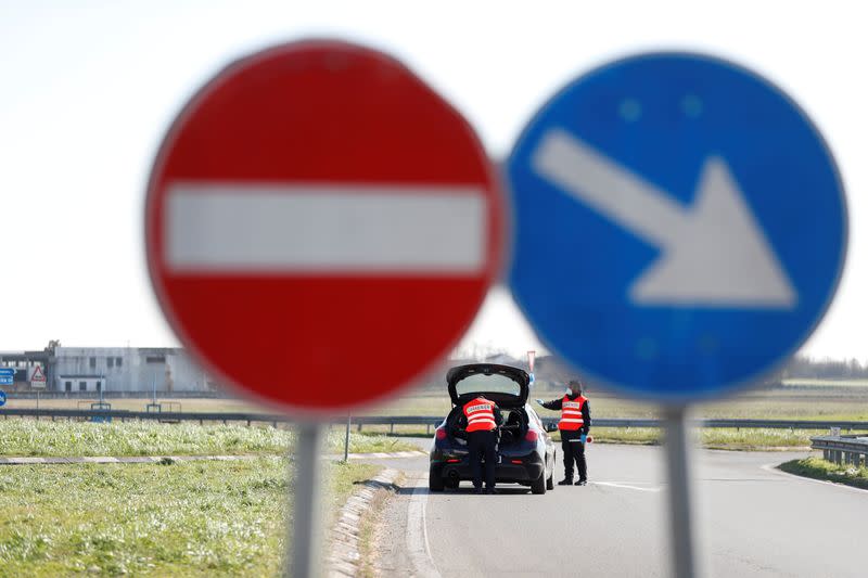 FILE PHOTO: Members of the Italian Carabinieri guard the entrance of the red zone of Casalpusterlengo