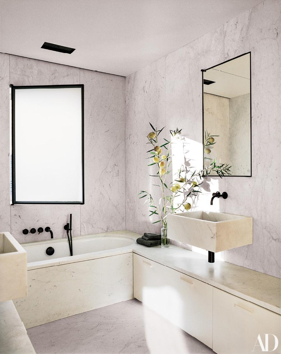 The children’s bath is clad in carrara marble. Bronze bath and sink fittings by <a rel="nofollow noopener" href="http://vola.com/en" target="_blank" data-ylk="slk:Vola;elm:context_link;itc:0;sec:content-canvas" class="link ">Vola</a>.