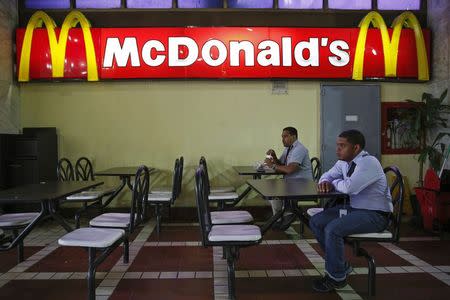 People dine at McDonald's in Caracas January 6, 2015. REUTERS/Carlos Garcia Rawlins