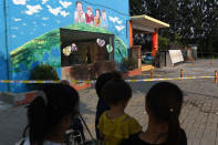 <p>Residents stand outside the gate of a kindergarten, where an explosion occurred a day earlier, in Fengxian in China’s eastern Jiangsu province on June 16, 2017. (Photo: Greg Baker/AFP/Getty Images) </p>