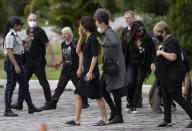 Alessandra Sampaio, center, arrives for the funeral of her husband British journalist Dom Phillips at the Parque da Colina cemetery in Niteroi, Brazil, Sunday, June 26, 2022. Family and friends paid their final respects to Phillips who was killed in the Amazon region along with the Indigenous expert Bruno Pereira. (AP Photo/Silvia Izquierdo)