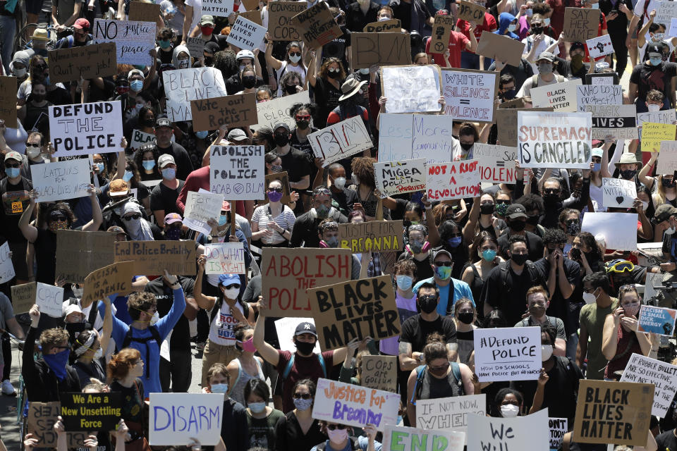 FILE - In this June 6, 2020, file photo, demonstrators march for Justice in honor of George Floyd on Ashland Avenue in Chicago. The federal government deliberately targeted Black Lives Matter protesters via heavy-handed criminal prosecutions in an attempt to disrupt and discourage the global movement that swept the nation last summer in the wake of the police killing of George Floyd, according to a new report released Wednesday, Aug. 18, 2021, by The Movement for Black Lives. (AP Photo/Nam Y. Huh, File)