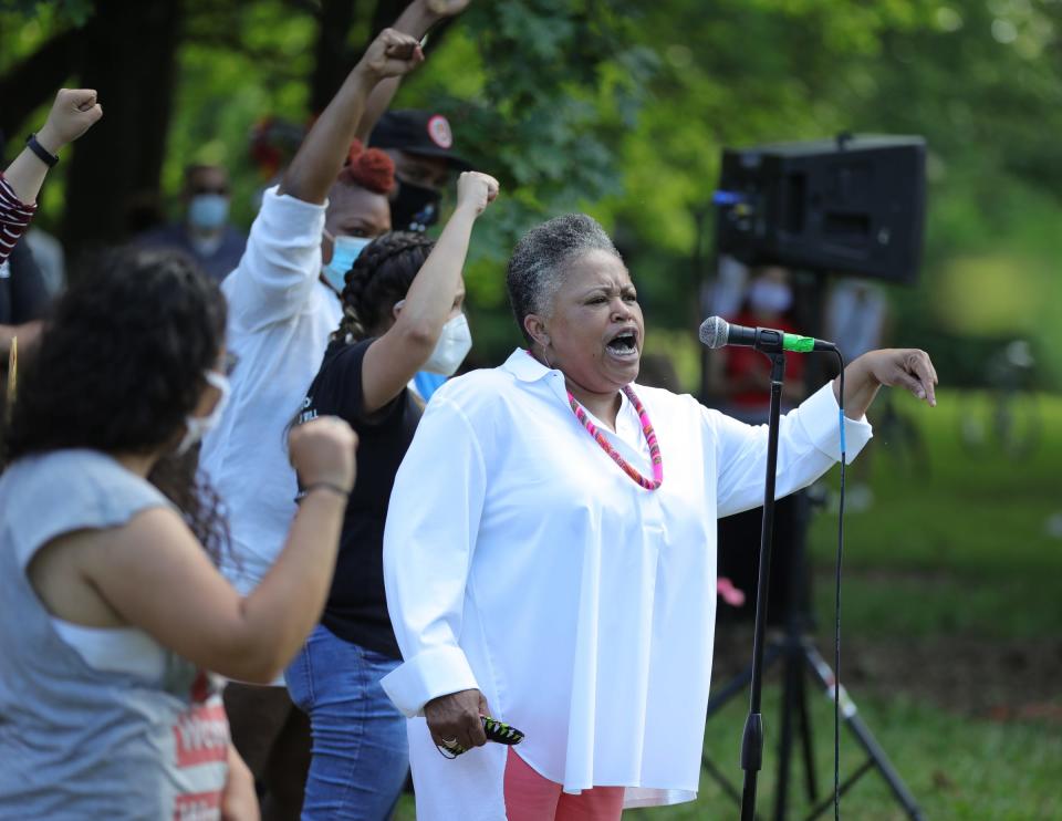 Monica Lewis-Peoples talks to the crowd in Patton Park before the march along Vernor Highway.