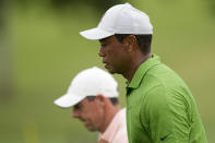 Tiger Woods and Rory McIlroy, of Northern Ireland, walk on the 18th hole during the second round of the PGA Championship golf tournament at Southern Hills Country Club, Friday, May 20, 2022, in Tulsa, Okla. (AP Photo/Matt York)