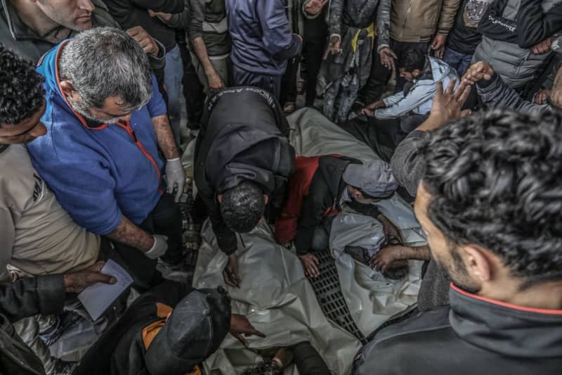 Palestinians surround the bodies of those who were killed in an Israeli air strike near a warehouse of the United Nations Relief and Works Agency for Palestine Refugees (UNRWA), at Al-Najjar Hospital in Rafah, southern Gaza Strip. Abed Rahim Khatib/dpa