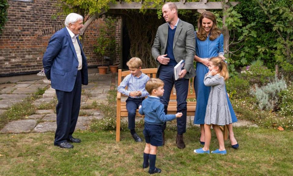 The Duke and Duchess of Cambridge and Prince George (seated), Princess Charlotte and Prince Louis with Sir David Attenborough (L) in the gardens of Kensington Palace.