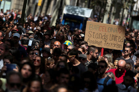 People march down Las Ramblas the day after a van crashed into pedestrians in Barcelona, Spain August 18, 2017. REUTERS/Sergio Perez