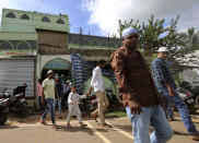 Young Muslim men leave a mosque after offering Friday prayers in Belagavi, India, Oct. 8, 2021. While interfaith unions between Hindus and Muslims are rare in India, Prime Minister Narendra Modi's ruling Bharatiya Janata Party, or BJP, and other Hindu nationalists have forcefully decried what they call "love jihad." The discredited conspiracy theory holds that supposedly predatory Muslim men deceive women to coerce them into changing their religion, with the ultimate aim of establishing domination in the majority-Hindu nation. (AP Photo/Aijaz Rahi)