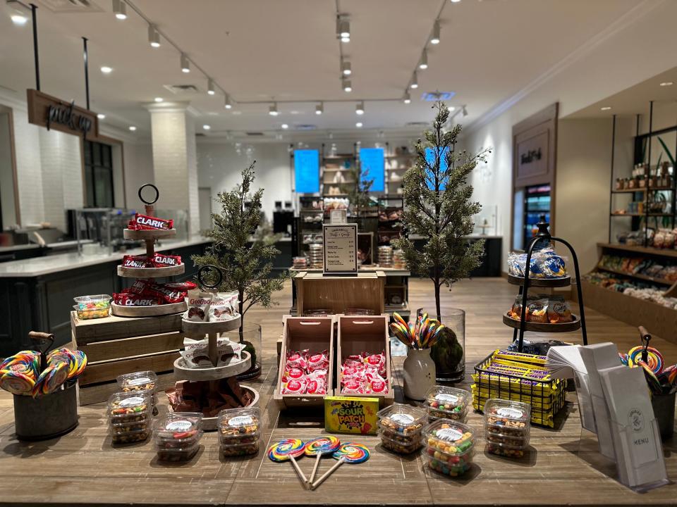Songbird Market in HeartSong resort with a display of candy and snacks in front of a coffee counter