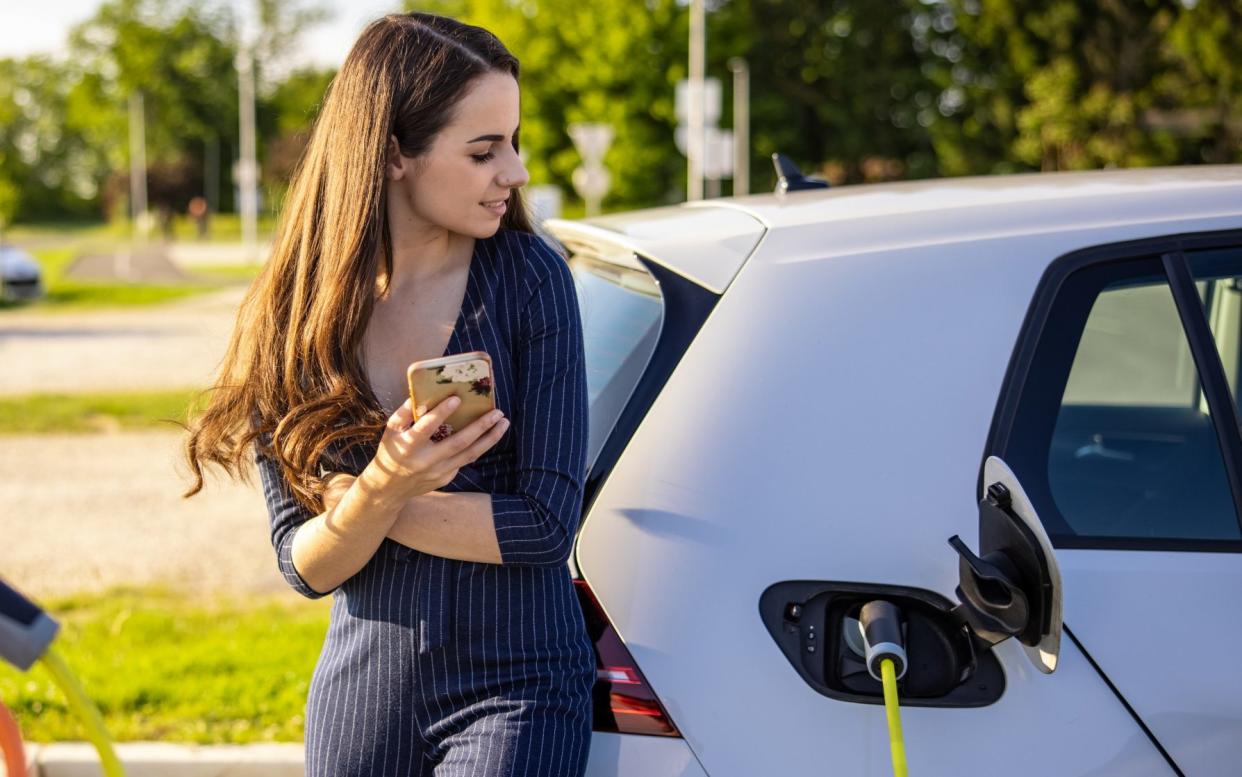 Woman charging up an EV