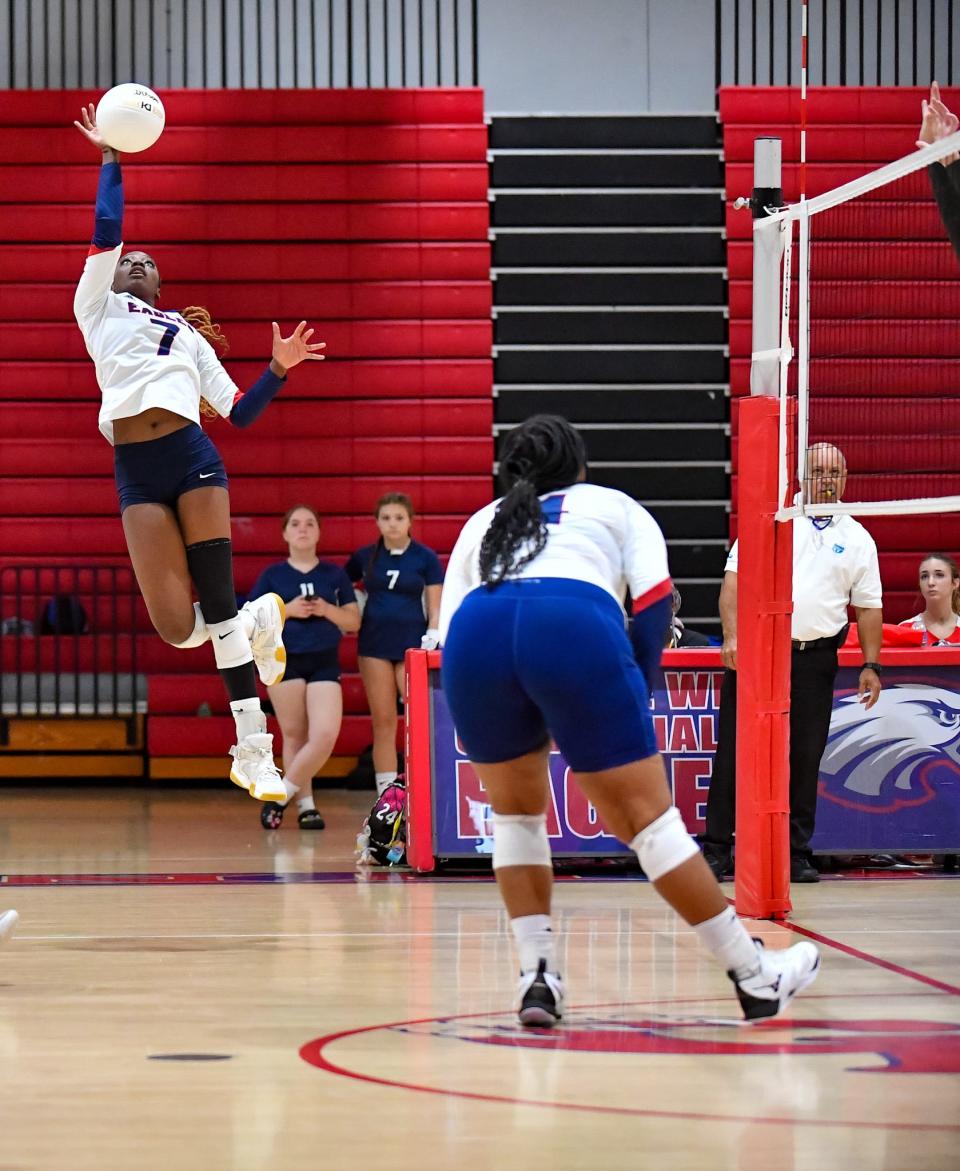 St. Lucie West Centennial's Shayla Henry (7) attempts a kill in a volleyball match against Martin County on Tuesday, Aug. 22, 2023, in Port St. Lucie. Centennial won in five sets.