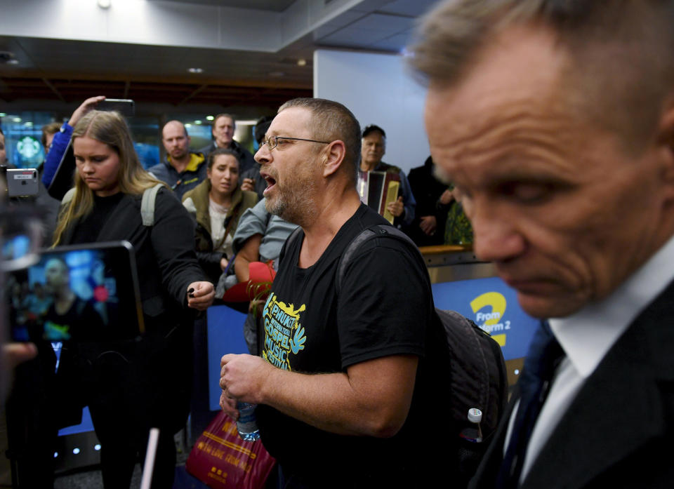 Spokesman and group leader Timo Valtonen, center, makes a statement to the press upon his arrival, with three other Finns after being deported from Malaysia, at the airport in Vantaa, Finland, Wednesday, Nov. 28, 2018. Four Finnish tourists who were arrested in Malaysia last week for distributing Christian materials in public places on a resort island have returned to Finland. (Antti Aimo-Koivisto/Lehtikuva via AP)