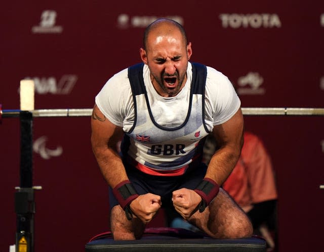 Great Britain's Ali Jawad celebrates after the second lift in the men’s -59 kg final