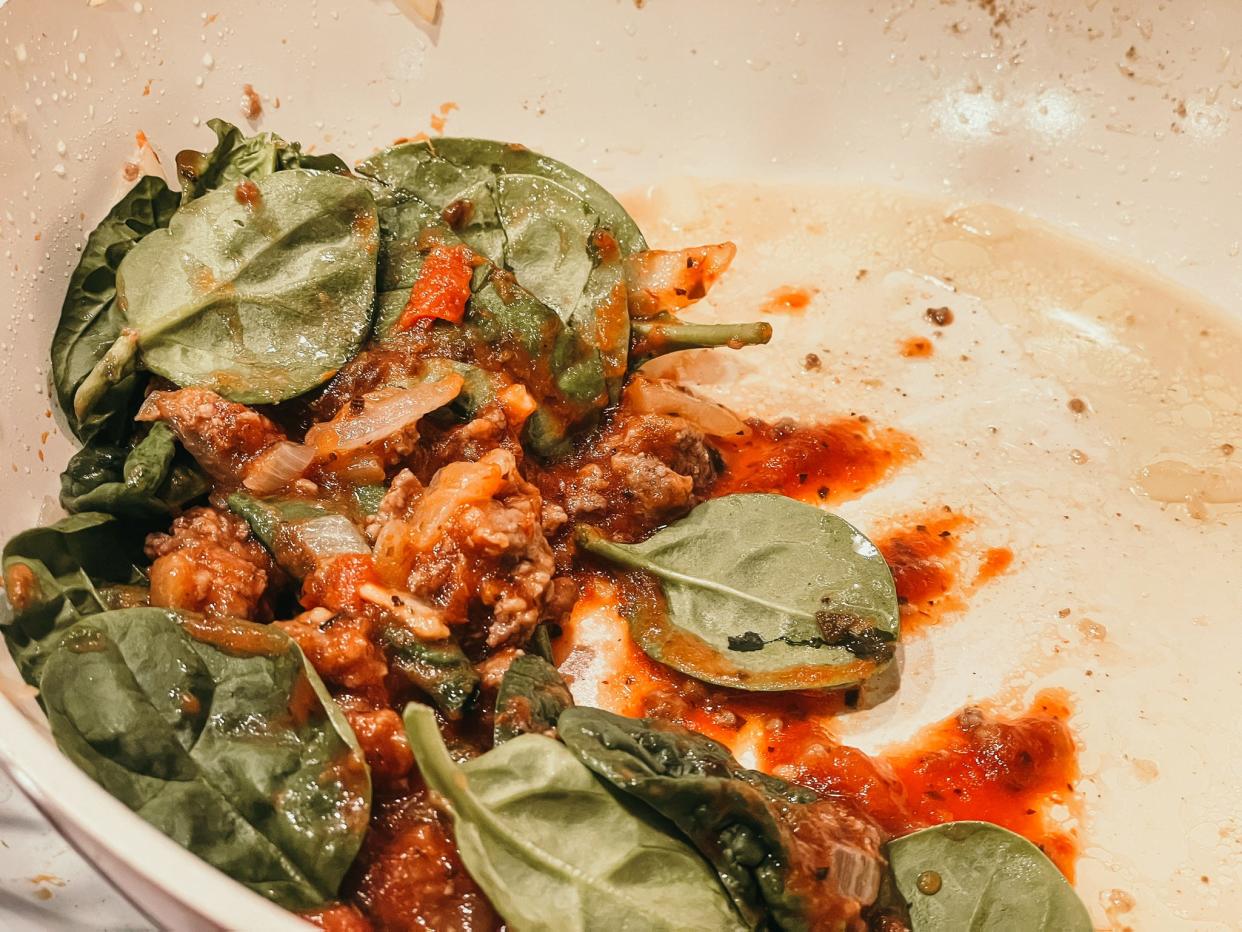 spinach, sausage, and marinara in a pan