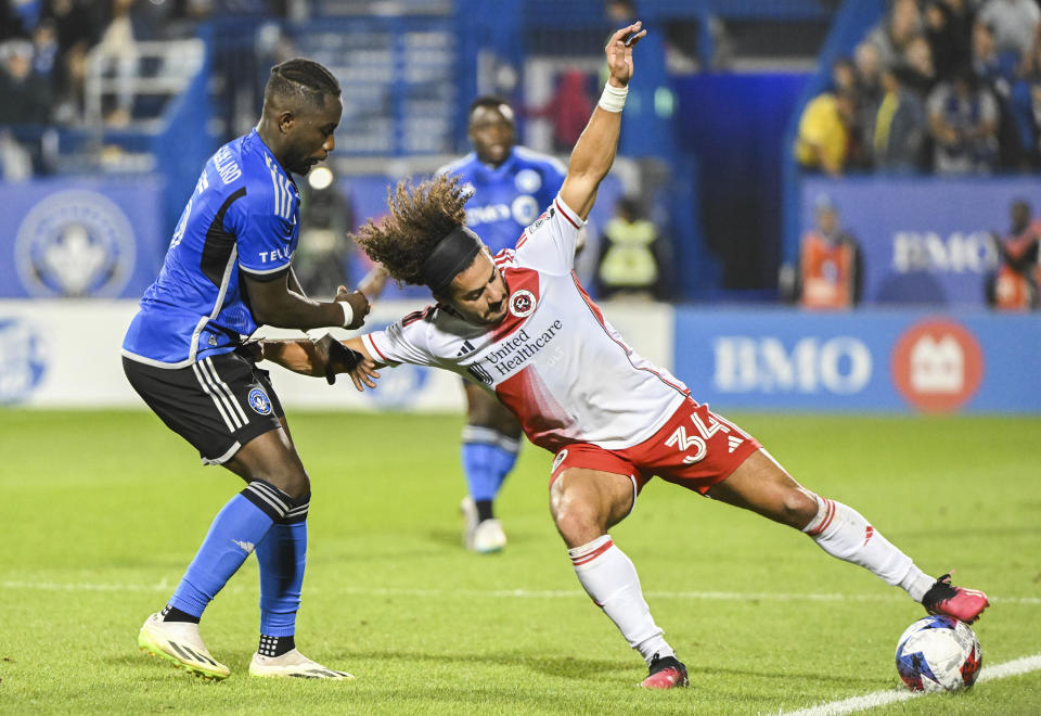 CF Montreal's Zachary Brault-Guillard, left, defends against New England Revolution's Ryan Spaulding during the second half of an MLS soccer match Saturday, Aug. 26, 2023, in Montreal. (Graham Hughes/The Canadian Press via AP)