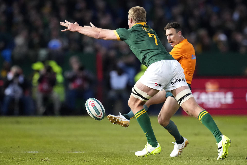 Australia's Nic White, right, kicks the ball as South Africa's Pieter-Steph du Toit tries to block it during the Rugby Championship test match between South Africa and Australia at Loftus Versfeld stadium in Pretoria, South Africa, Saturday, July 8, 2023. (AP Photo/Themba Hadebe)