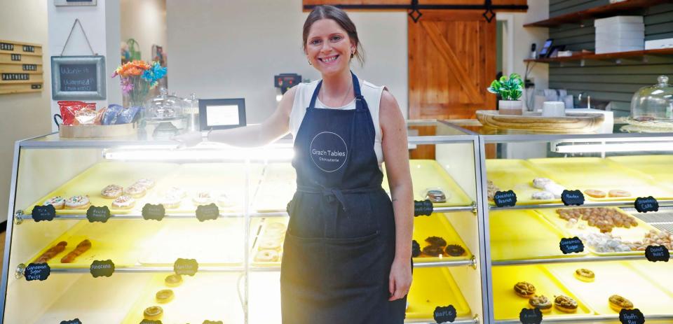 Graz’n Tables Charcuterie & Bakery Bar is a bakery owned by Chelsey Barringer where doughnuts and charcuterie come together. Barringer stands in front of a display of doughnuts and other baked goods on Aug. 3, 2023, at the bakery, which is located at 1996 S. Houston Levee Road in Collierville.